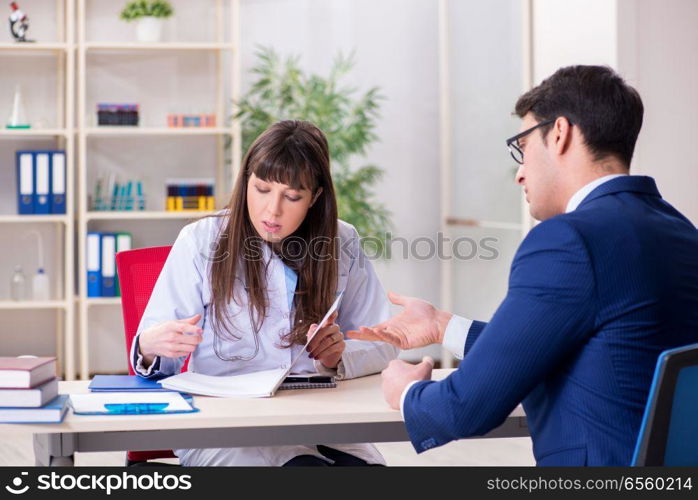 Businessman discussing health issues with doctor