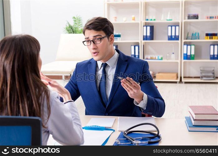 Businessman discussing health issues with doctor