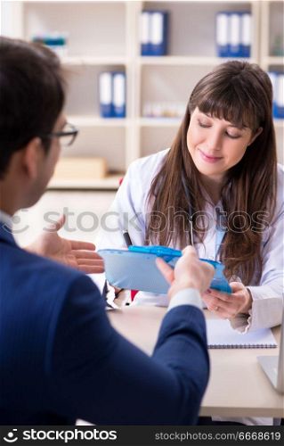 Businessman discussing health issues with doctor