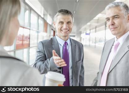 Businessman discussing with colleagues at railroad platform