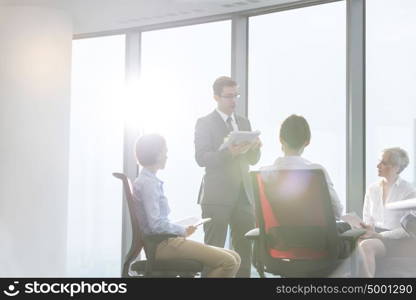 Businessman discussing with colleagues in boardroom at office