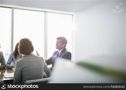 Businessman discussing with female team in conference room