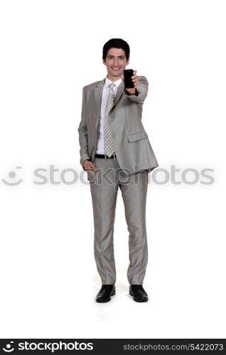 Businessman displaying mobile telephone