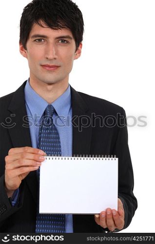 Businessman displaying notepad