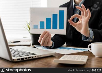 businessman doing ok sign while holding growth chart. Resolution and high quality beautiful photo. businessman doing ok sign while holding growth chart. High quality beautiful photo concept