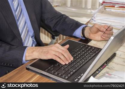 Businessman doing shopping on internet in office