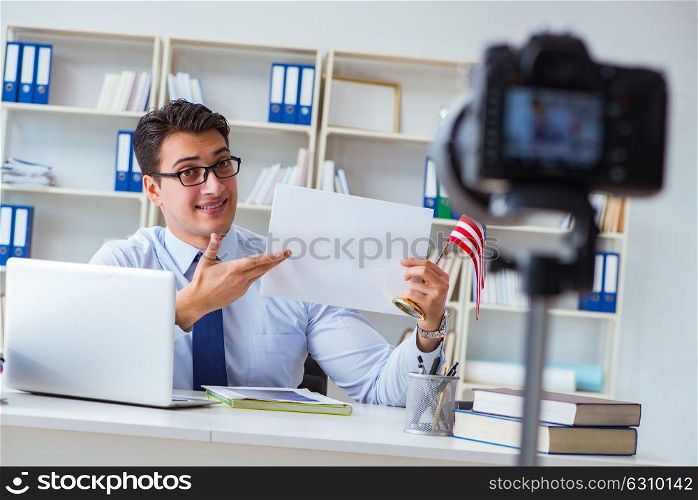Businessman doing webcast with blank sheet of paper