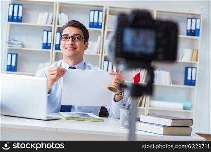 Businessman doing webcast with blank sheet of paper. The businessman doing webcast with blank sheet of paper