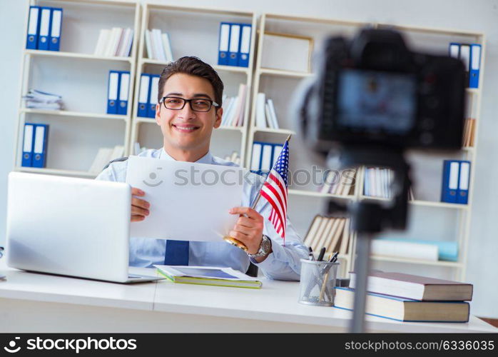 Businessman doing webcast with blank sheet of paper