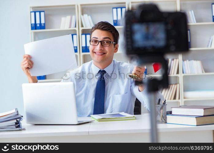 Businessman doing webcast with blank sheet of paper