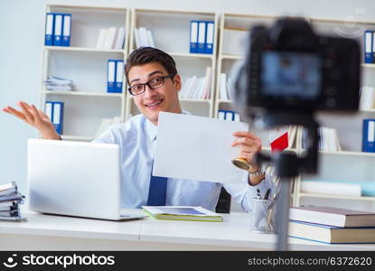 Businessman doing webcast with blank sheet of paper