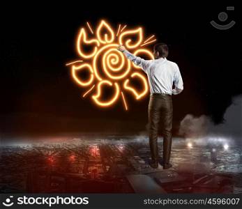 Businessman draw the flower. Businessman draws fire flower on dark sky