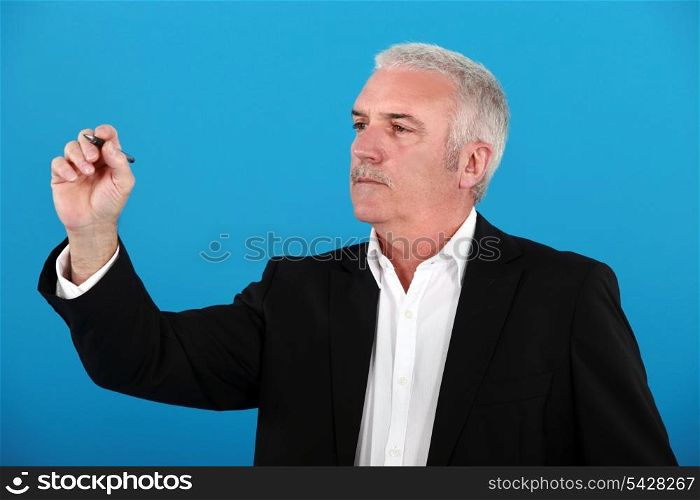 Businessman drawing a graph on a glass screen