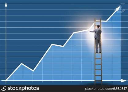 Businessman drawing charts standing on ladder