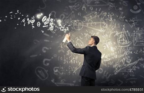 Businessman drawing his ideas. Businessman spraying his business ideas from aerosol can