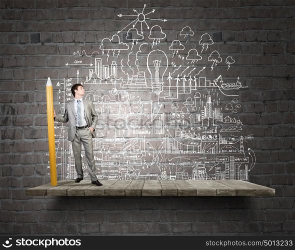 Businessman drawing plan strategy success with huge pencil. My great plan