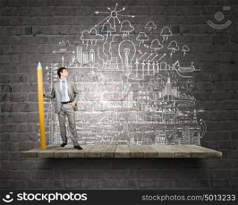 Businessman drawing plan strategy success with huge pencil. My great plan