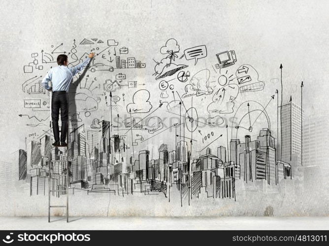 Businessman drawing sketch. Back view of businessman drawing sketch on wall