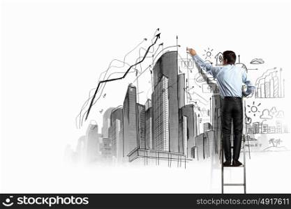 Businessman drawing sketch. Back view of businessman drawing sketch on wall