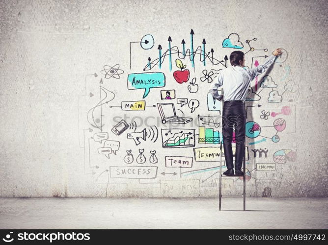 Businessman drawing sketch. Back view of businessman drawing sketch on wall