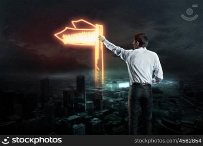 Businessman draws a variety of signs. Businessman draws a variety of signs on the dark sky