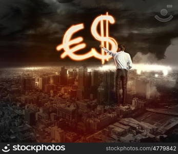 Businessman draws a variety of signs. Businessman draws a variety of signs on the dark sky