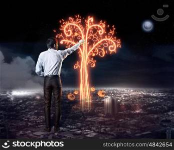 Businessman draws a variety of signs. Businessman draws a variety of signs on the dark sky