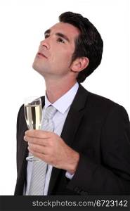 Businessman drinking champagne alone