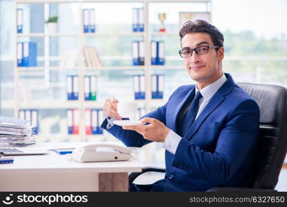 Businessman drinking coffee in the office during break. The businessman drinking coffee in the office during break