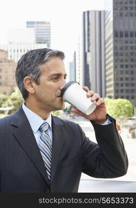 Businessman Drinking Takeaway Coffee Outside Office