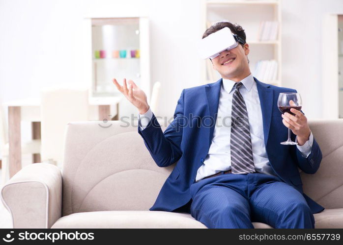 Businessman drinking wine sitting at home