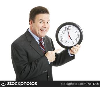 Businessman eagerly pointing to a clock that reads almost 5:00 pm. He&rsquo;s ready to go home. Isolated.