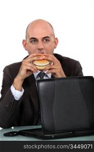 businessman eating a hamburger