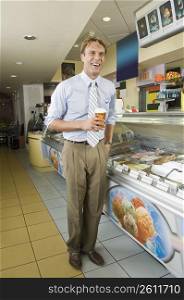 Businessman eating an ice cream in an office cafeteria