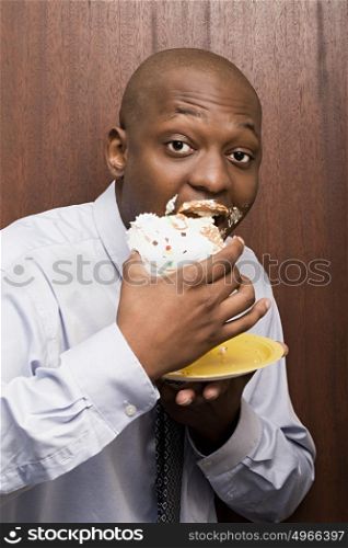 Businessman eating cake