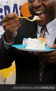 Businessman eating cake