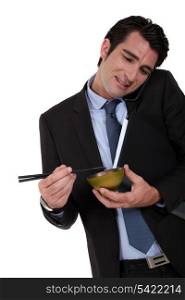 Businessman eating Chinese food