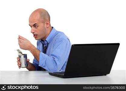 businessman eating from tin
