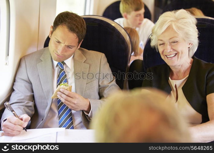 Businessman Eating Sandwich On Train Journey