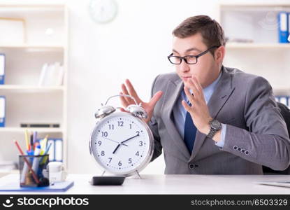 Businessman employee in urgency and deadline concept with alarm . Businessman employee in urgency and deadline concept with alarm clock. Businessman employee in urgency and deadline concept with alarm