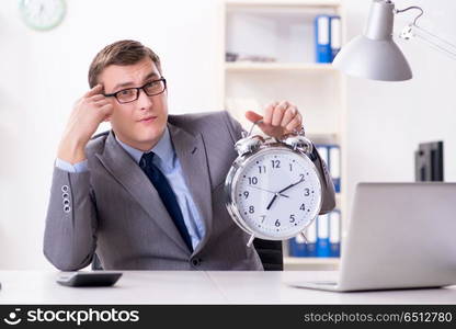 Businessman employee in urgency and deadline concept with alarm . Businessman employee in urgency and deadline concept with alarm clock. Businessman employee in urgency and deadline concept with alarm