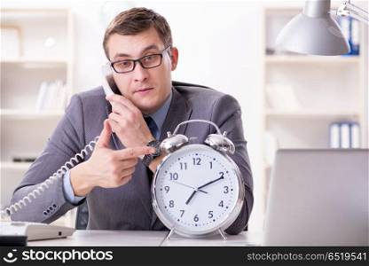 Businessman employee in urgency and deadline concept with alarm . Businessman employee in urgency and deadline concept with alarm clock. Businessman employee in urgency and deadline concept with alarm