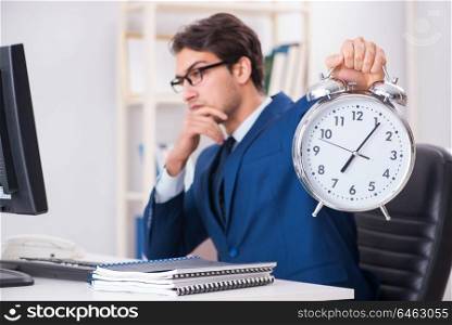 Businessman employee in urgency and deadline concept with alarm clock. Businessman employee in urgency and deadline concept with alarm