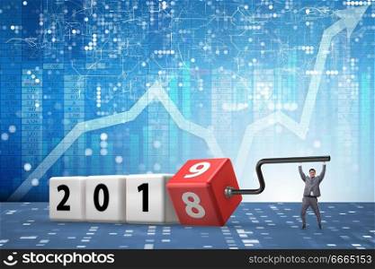 Businessman employee rotating cube to reveal number 2019
