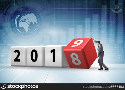 Businessman employee rotating cube to reveal number 2019