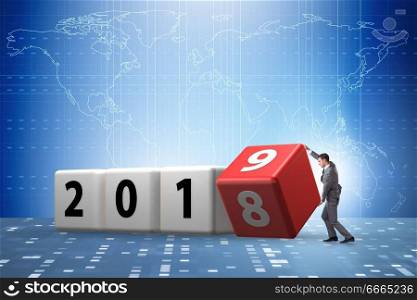 Businessman employee rotating cube to reveal number 2019. The businessman employee rotating cube to reveal number 2019