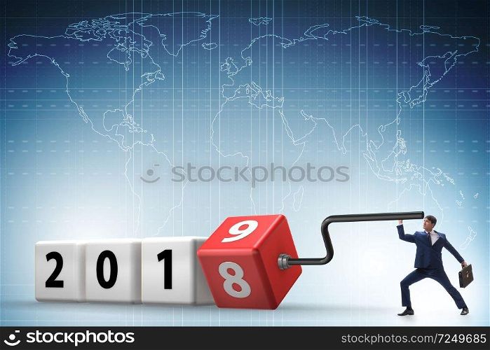 Businessman employee rotating cube to reveal number 2019