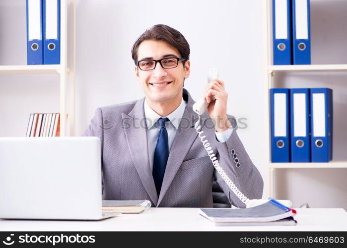 Businessman employee talking on the office phone