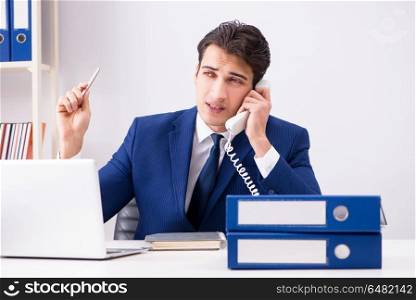 Businessman employee talking on the office phone