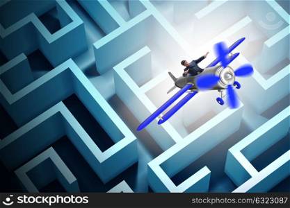 Businessman escaping from maze on airplane